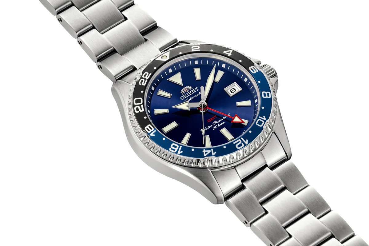 Angled view of the Orient RA-BC0003L GMT watch with a bluedial, black-and-blue 24-hour bezel, and stainless steel case and bracelet.