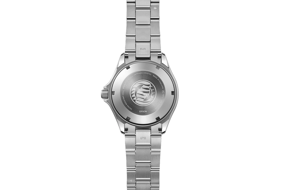 Rear view of an Orient Kamasu GMT watch showing the stainless steel bracelet and solid caseback engraved with a stylized globe design.