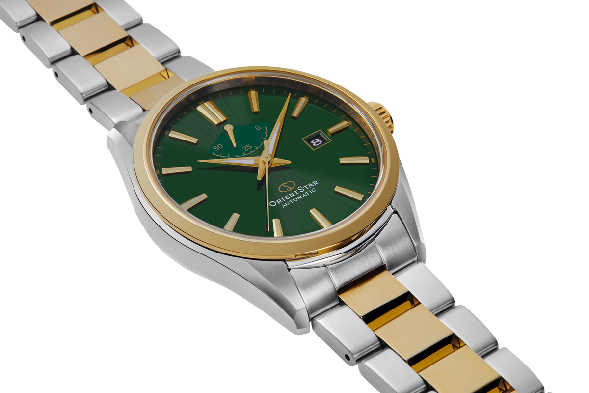 A two-tone wristwatch with a green dial, gold-tone bezel and hands, and a silver-and-gold link bracelet, shown on a clean white background.

Front facing stock photo 
Orient Star RE-AU0405E