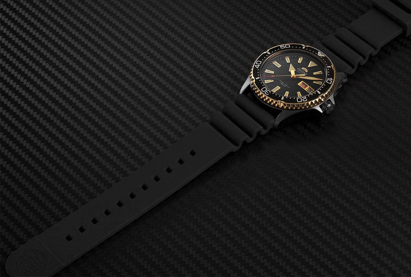 Close-up of diver watch with black silione diver's strap.